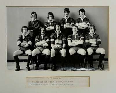 Formal photograph showing Mr A.V. Edwards and three team members standing behind five seated team members