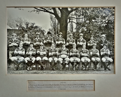Formal photograph showing eight players standing with Mr Hobson Edwards on their right standing behind nine seated players