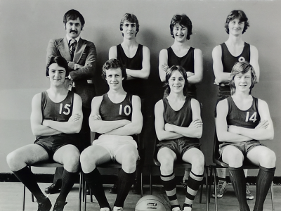 Formal photograph showing three players with Mr Stansfield on their left standing behind four seated players